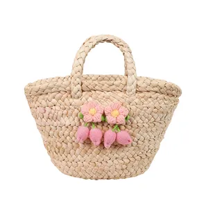 Cute straw handbag with crochet flower decorations and round handles in a fresh summer style