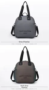 Detail view of grey and dark grey waterproof handbags with adjustable fabric straps