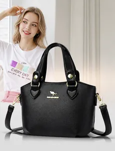 Détail d'un sac à main en cuir grainé noir avec fermoir doré et logo kangourou
