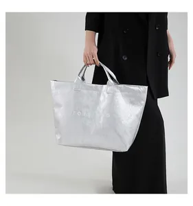 Detailed macro view of shiny silver tote bag texture with metallic pleated finish