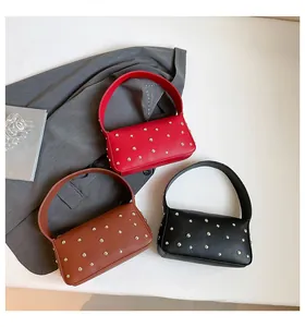 Detailed arrangement of rivet baguette bags in red, brown, and black colors