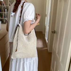 Handmade cream crochet tote bag with wooden beads and brown straps for summer beach style