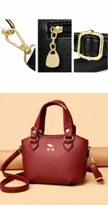 Détails des crochets dorés et de la boucle sur le sac à main en cuir grainé rouge foncé