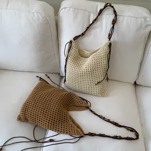 Handwoven wax rope tote bag with wooden bead shoulder straps in cream and brown