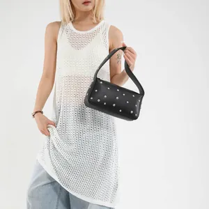 Fashionable black pebbled leather baguette bag with silver rivets and wide strap