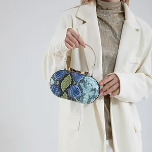 Snakeskin pattern clutch bag with gold bow clasp and metal ring handle for women