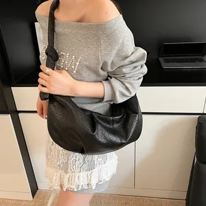 Black large capacity faux leather shoulder bag with pleated texture and knot strap detail