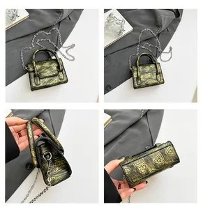 Detail view of mini bronze chain bag with leopard pattern and metal hardware