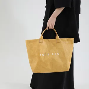 Minimalist ginger yellow PVC tote bag with TOTE BAG print and textured finish