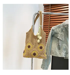 Detailed handmade crochet straw tote bag with sunflower pattern and tulip charm decoration