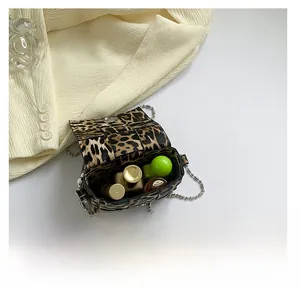 Detailed view of leopard print crossbody bag showing interior capacity and magnetic closure
