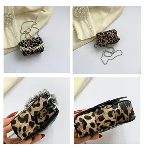 Detailed close-up views of leopard print crossbody bag with pearl chain and silver hardware