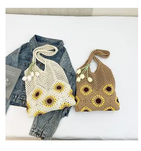 Detailed close-up of handmade crochet tote bags with sunflower patterns and tulip charms