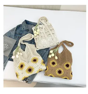 Three crochet tote bags with sunflower patterns and tulip pendants on a white background