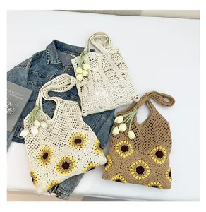Detailed macro view of three crochet woven tote bags with floral sunflower embroidery