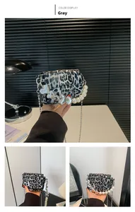 Detail of grey leopard print crossbody bag with pearl handle and heart metal chain