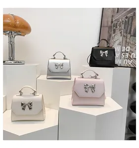 Detailed group view of four stylish flap crossbody bags with metallic bow clasps