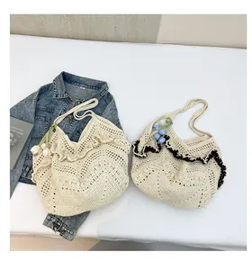 Detail of hand-crocheted knit shoulder bag with hollow patterns and tulip flower accents