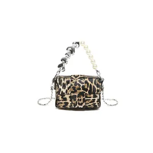 Leopard print crossbody bag with pearl and silver heart handle on white background