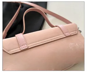 Detail shot of the pink crossbody bag back with fine stitching and dual handle design