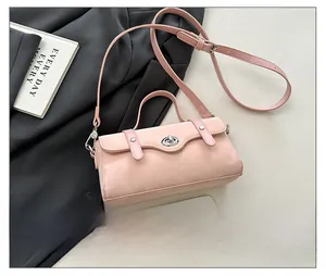 Pink crossbody bag size comparison with smartphone showing premium matte texture and hardware