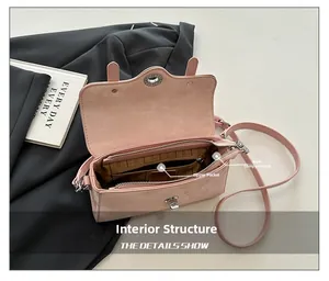 Detail view of pink suede shoulder bag interior with main compartment and zipper pocket