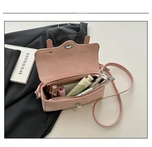 Internal capacity of pink leather flap bag showing storage for makeup and essentials