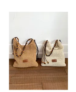 Detail of hand-woven crochet tote bags featuring wooden bead straps and boho texture