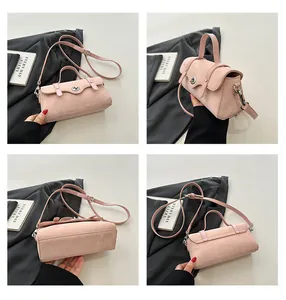 Detail view of pink crossbody bag with matte texture, metal twist lock and Four-grid layout