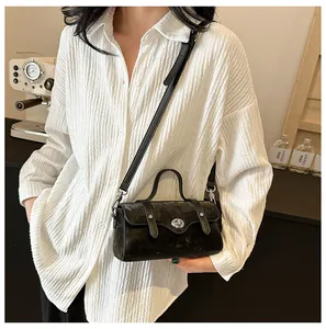 Fashionable black crossbody mini bag with silver metal lock and textured matte finish