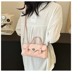 Detail of pink vintage texture handbag with silver twist lock and crossbody strap