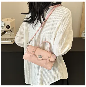 Close-up of a pink crossbody bag featuring litchi texture leather and silver turn-lock