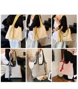Multiple views of large striped canvas tote bag with contrast trim and charm detail