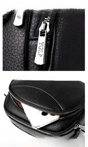 Detail of silver zipper pull with YGLP logo and front pocket on black lychee leather bag