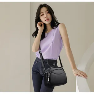 Minimalist black lychee texture PU leather crossbody bag with dual zipper compartments