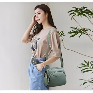 Olive green litchi grain PU leather crossbody round bag for women with triple zipper layers