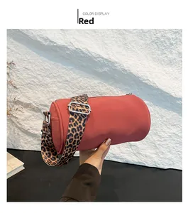 Dettaglio borsa a cilindro rossa con ampia tracolla regolabile con stampa leopardata