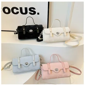 Detail view of stylish square shoulder bags in black, white, blue, and pink faux suede finish
