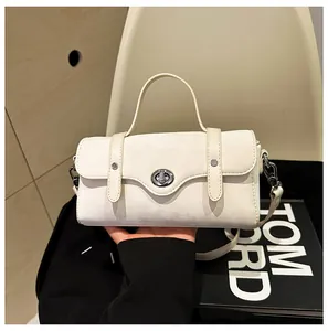 Detail of creamy white crossbody bag with matte finish and elegant silver twist lock