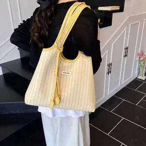 Chic yellow and white striped tote bag with leather handles and large capacity