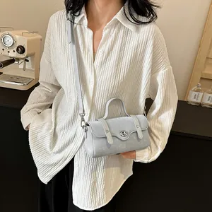 Light blue minimalist crossbody bag with vintage texture and silver twist lock closure