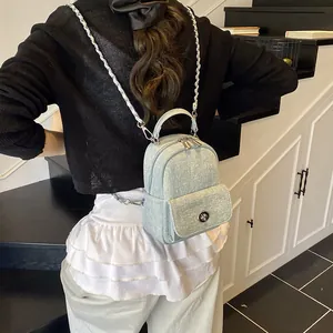 Mini light blue denim backpack with chain strap and metallic buckle for women