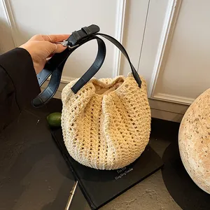 Retro woven hollow beach bucket bag with cream fabric and black leather shoulder strap