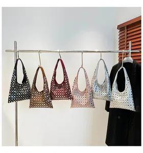Chic rivet shoulder bags in six vibrant colors displayed on a minimalist shop rack