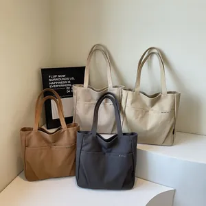 Minimalist canvas tote bags in earthy tones with large capacity for daily commuting