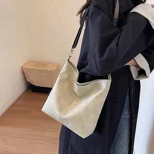 Minimalist beige hobo tote bag with vintage leather texture and gold metal hardware