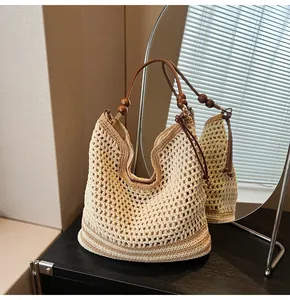 Detail of woven tote bag showing hollow mesh pattern with wood beads and leather strap