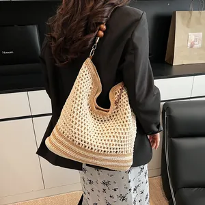 Chic woven hobo tote bag with dark wood bead strap and beige hollow knit design