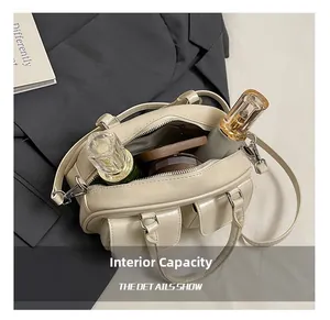 Detail view of the beige shoulder bag interior compartment showing large storage capacity