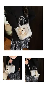 Close-up of silver glitter bucket bag featuring a cute plush puppy charm and metallic handles